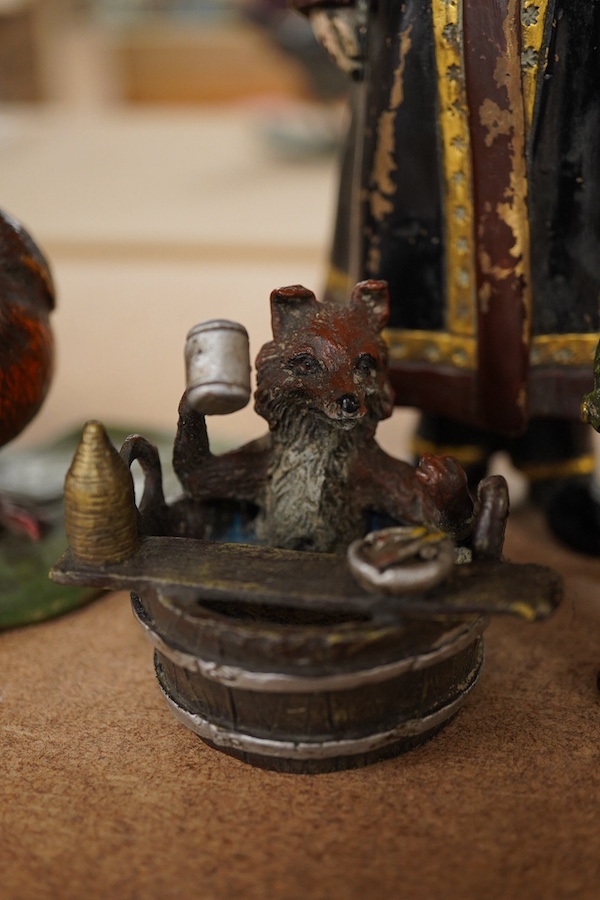 Three Austrian cold painted bronzes together with a Russian example of a gentleman in military dress, largest 18cm high. Condition - good